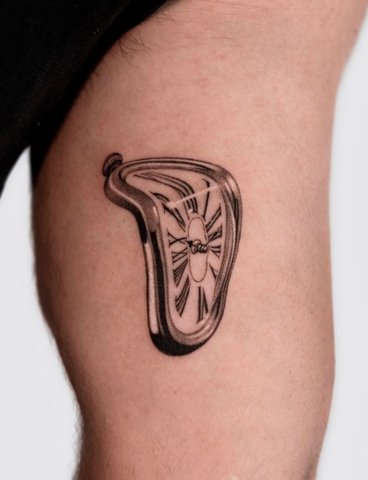 A couple sits on a rock, gazing at a scenic valley below